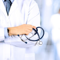 Portrait an unknown male doctor holding a stethoscope